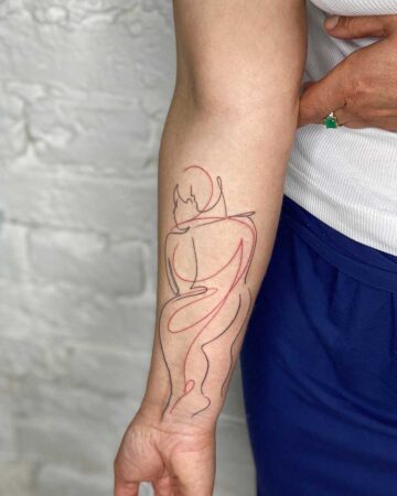 A close-up of an arm featuring a line art tattoo of two figures embracing. The tattoo symbolizes body positivity and self-love through its artistic representation of human connection.