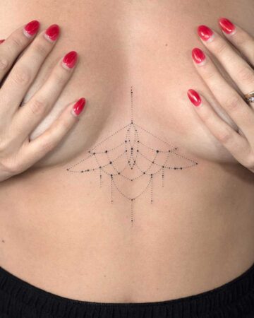 A woman's chest featuring a delicate, minimalist fine line sternum tattoo. The design is geometric with dotted lines and small circles, framed by her hands with bright red nail polish.