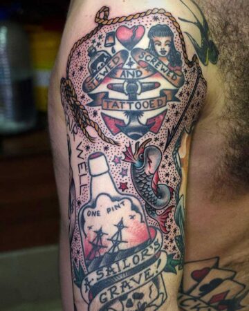 Traditional sailor tattoo on an arm featuring a bottle labeled "One Pint, A Sailor's Grave!", an anchor, and the phrase "Stewed and Screwed and Tattooed".