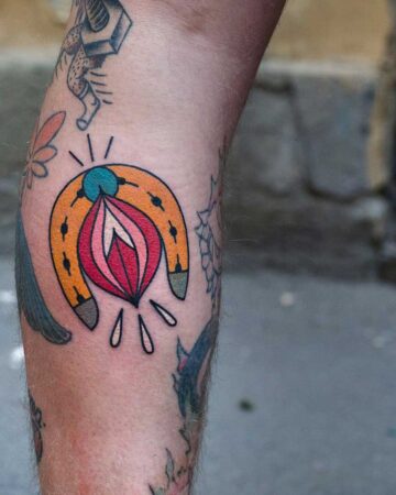 color tattoo on the leg on the calf horseshoe traditional tattoo thick lines horseshoe for luck