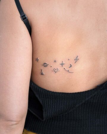 Back tattoo of stars, planet, and heart symbols Done by tattoo artists in our fine line tattoo studio parlour shop Canggu, Bali