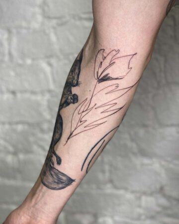 Forearm tattoo with abstract leaves and animal design on light skin Done by tattoo artists in our fine line tattoo studio parlour shop Canggu, Bali