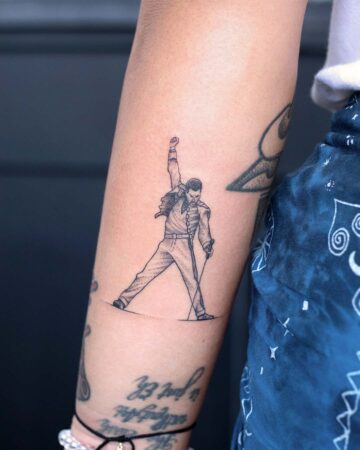mini tattoo on the arm black and white freddie mercury fine lines