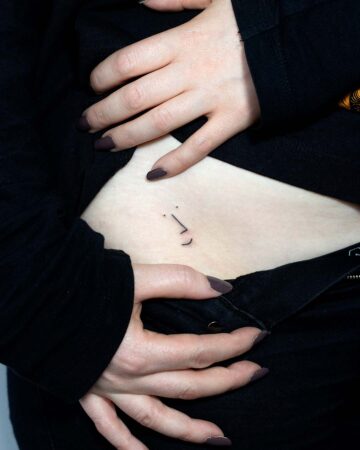 Minimalist face tattoo on a woman's side, a small fine line design. By tattoo artists in tattoo studio Canggu, Bali