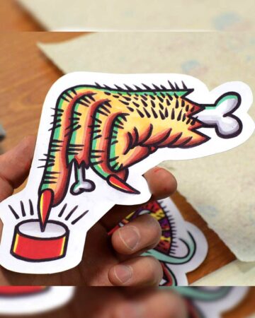 Tattoo flash of a hand with chicken leg fingers pressing a button. Bold lines and vibrant colors. By tattoo artists in tattoo studio Canggu, Bali