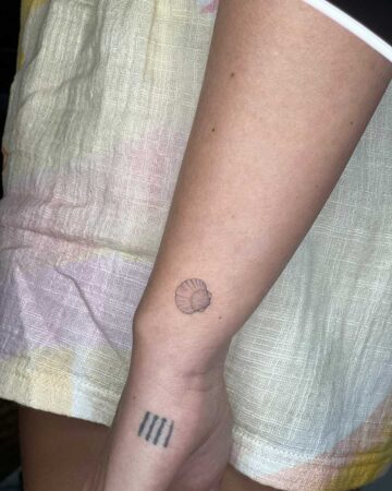 tattoo fine line tiny mini black single needle minimalistic on the hand sea shell