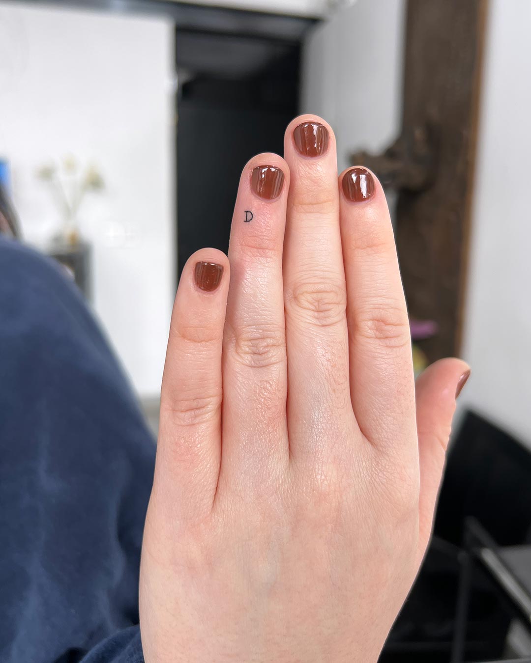 tattoo script lettering on the finger fineline