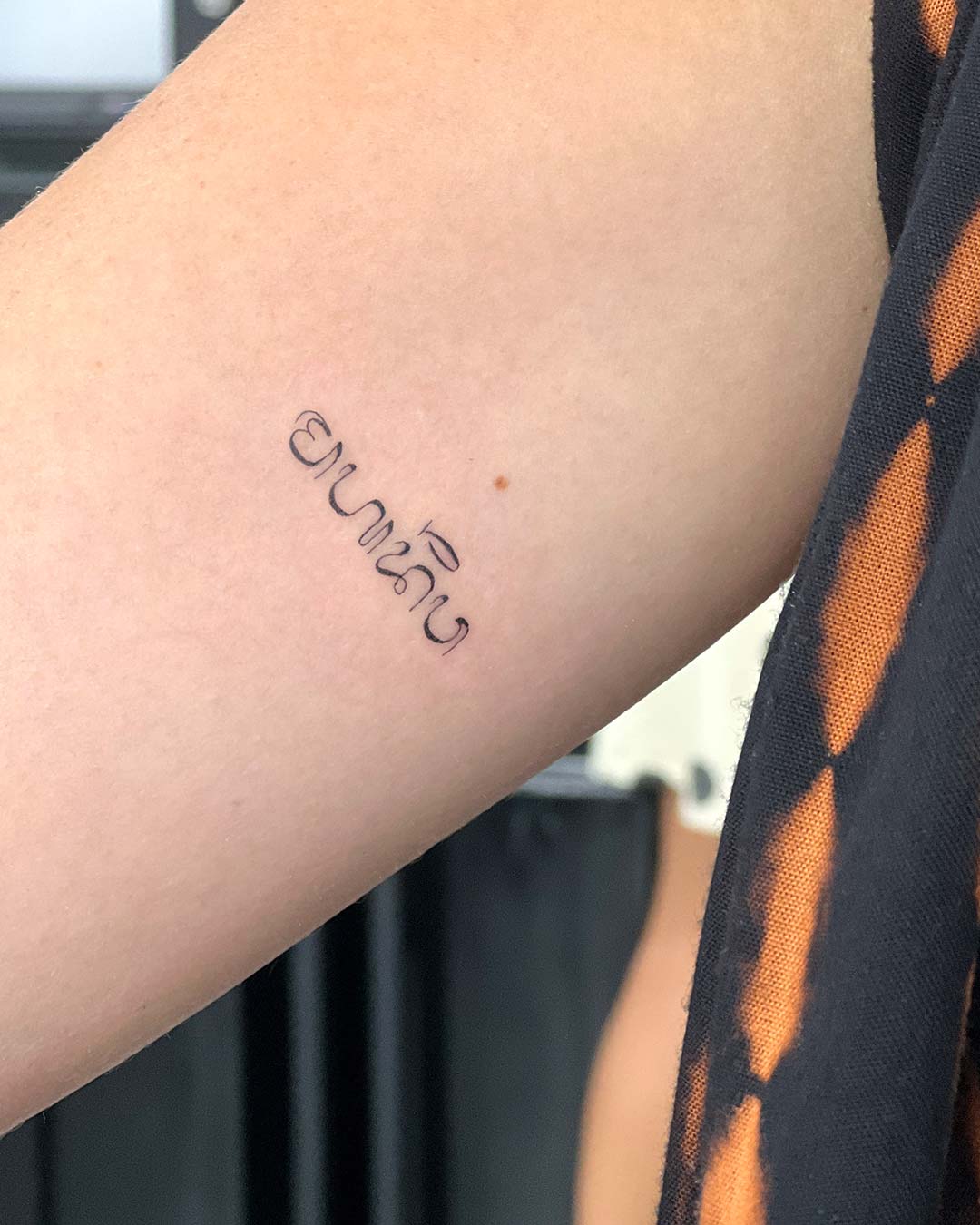 tattoo script lettering on the hand fineline balinese fineline