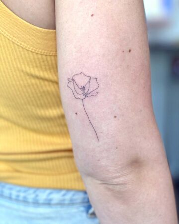 tattoo black minimalistic on the hand fine line flower poppey