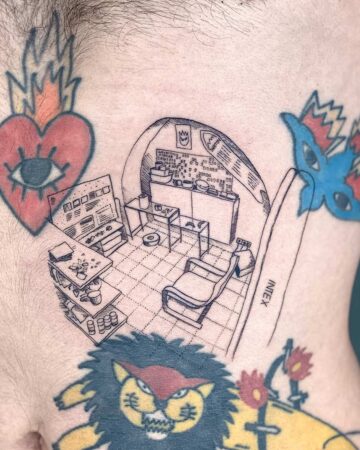 Detailed line art tattoo of a stylized, futuristic room interior, featuring a desk with a screen, a kitchen area, a recliner, and a robotic vacuum. The tattoo is inked on the body, surrounded by other colorful tattoos. Done by tattoo artists in our fine line tattoo studio parlour shop Canggu, Bali