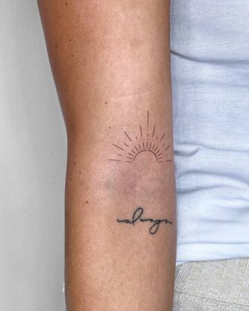 Minimalist sun tattoo with radiating lines above the word "always" in cursive, inked on the inner forearm. A simple yet meaningful tattoos design. Done by tattoo artists in our fine line tattoo studio parlour shop Canggu, Bali