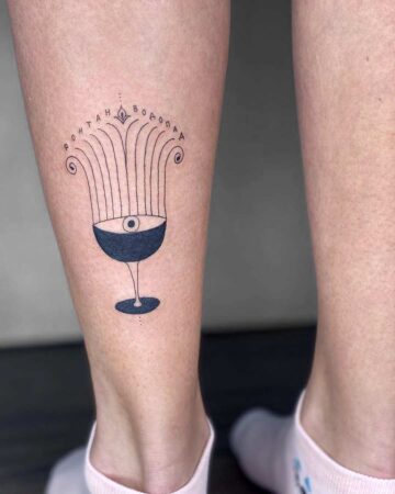 Elegant black ink tattoo on leg By tattoo artists in tattoo studio Canggu, Bali