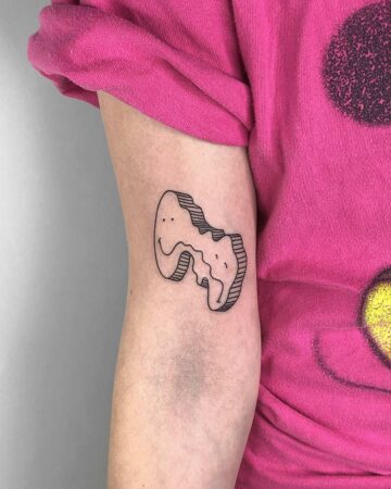 A minimalist line art tattoo of two smiling faces intertwined on a person's arm. The tattoo is black and white, with a 3D effect. done by artists in our fine line tattoo studio Canguu Bali