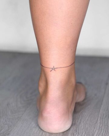 Delicate ankle tattoo featuring a thin line and a small star design. This minimalist tattoo is a perfect example of small tattoo ideas, ideal for those seeking subtle body art. Done by tattoo artists in our fine line tattoo studio parlour shop Canggu, Bali