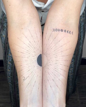 Matching celestial tattoos on two forearms. One arm displays a sunburst design with a dark half-circle, while the other features a moon phase sequence. A beautiful example of matching tattoos. Done by tattoo artists in our fine line tattoo studio parlour shop Canggu, Bali
