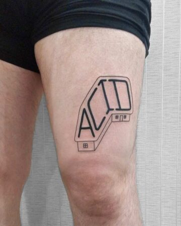 Black minimalist "ACID" tattoo on a person's thigh. The design features bold, geometric letters and small house illustrations, showcasing a modern minimalist aesthetic. This tattoo is a cool example of body art. Done by tattoo artists in our fine line tattoo studio parlour shop Canggu, Bali