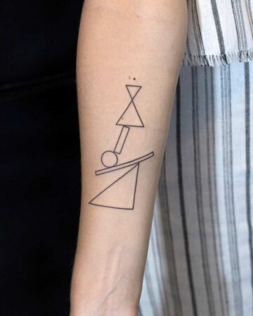 A minimalist geometric tattoo featuring a collection of shapes, including triangles, a circle, and a horizontal line, inked on a person's arm. The design showcases a line art tattoo style, perfect for those seeking a simple yet striking geometric tattoo. Done by tattoo artists in our fine line tattoo studio parlour shop Canggu, Bali