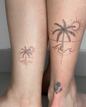 Matching tattoos on legs: a palm tree scene with sun and waves, one larger than the other. Couples tattoo inspiration. Created by expert tattoo artists in Canggu Bali.