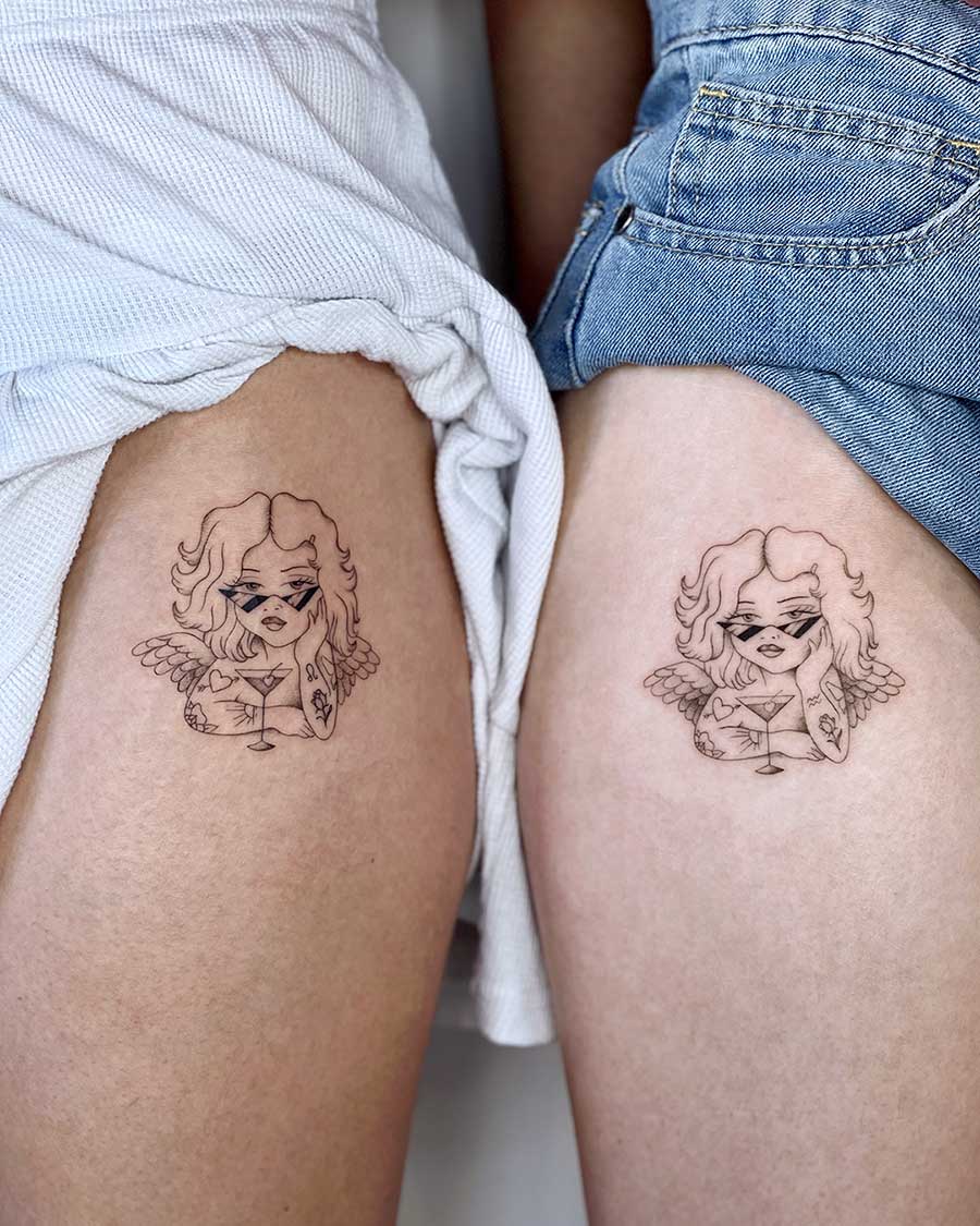 Matching tattoos of a stylish angel with sunglasses and a cocktail on two thighs. Perfect for couples seeking unique matching tattoos. Created by the best tattoo artists in Canggu Bali, expert in Bali tattoo design.