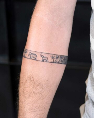 black and white tattoo graphics bracelet on the arm on the forearm thin lines elephants jungle palm trees dowork graphics