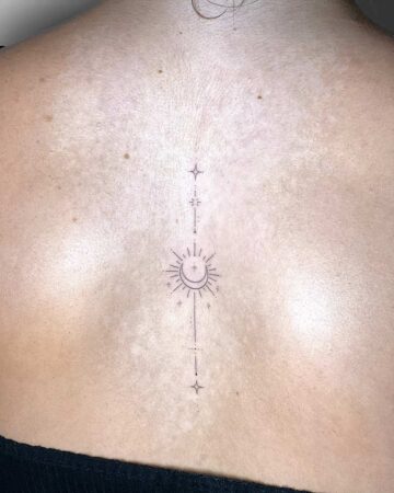 Delicate celestial back tattoo with sun, moon, stars, and lines. A beautiful celestial design. By tattoo artists in tattoo studio Canggu, Bali
