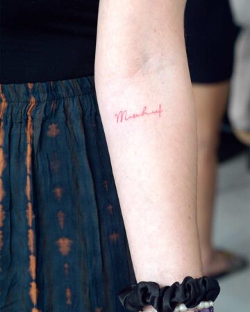 tattoo script lettering on the hand fineline