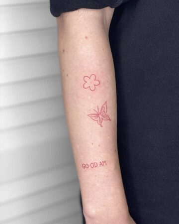 red tattoo on the arm on the shoulder abstract mini flower field butterfly inscription minimalism thin lines for girls female