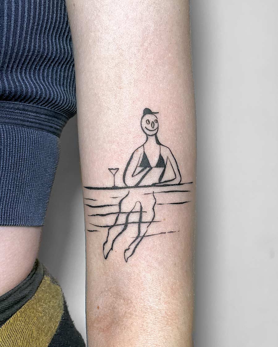 Minimalist tattoo design of a woman relaxing at a beach bar, wearing a bikini and enjoying a cocktail. The simple line art evokes a relaxed summer vacation vibe. Done by tattoo artists in our fine line tattoo studio parlour shop Canggu, Bali
