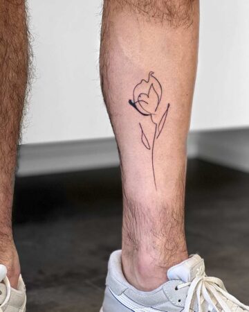 tattoo black minimalistic on the foot leg flower