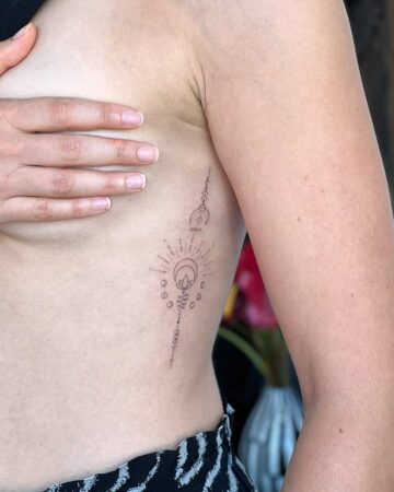 tattoo pattern fineline sun on the back woman thin line single needle bali