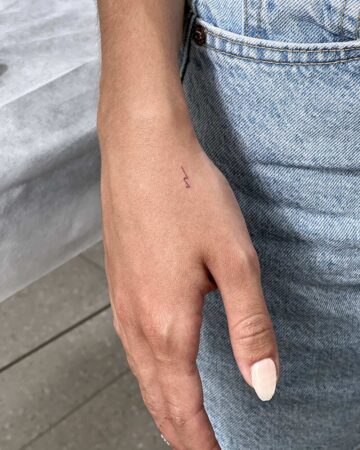 tattoo script lettering on the arm fineline