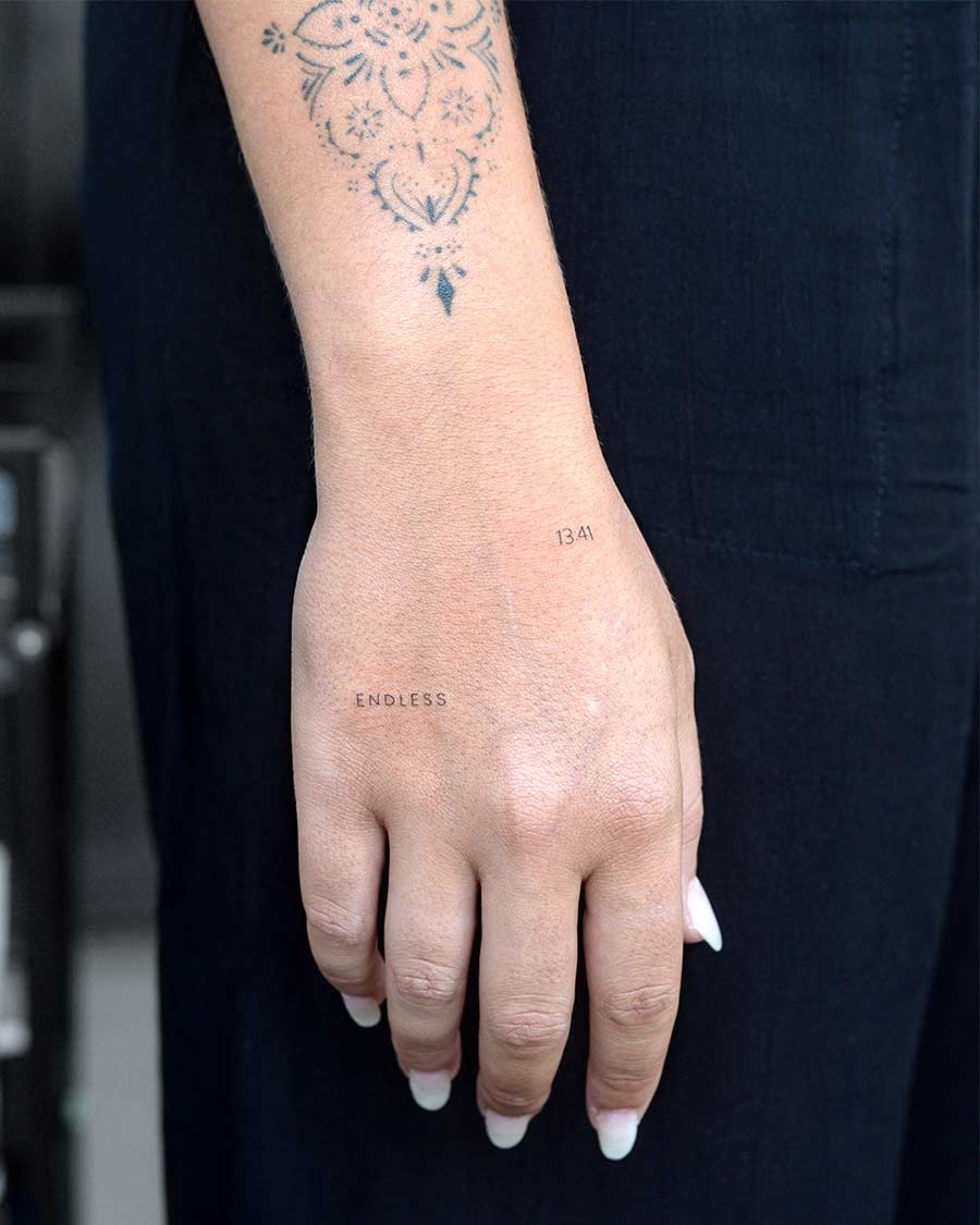 tattoo script lettering on the arm fineline endless