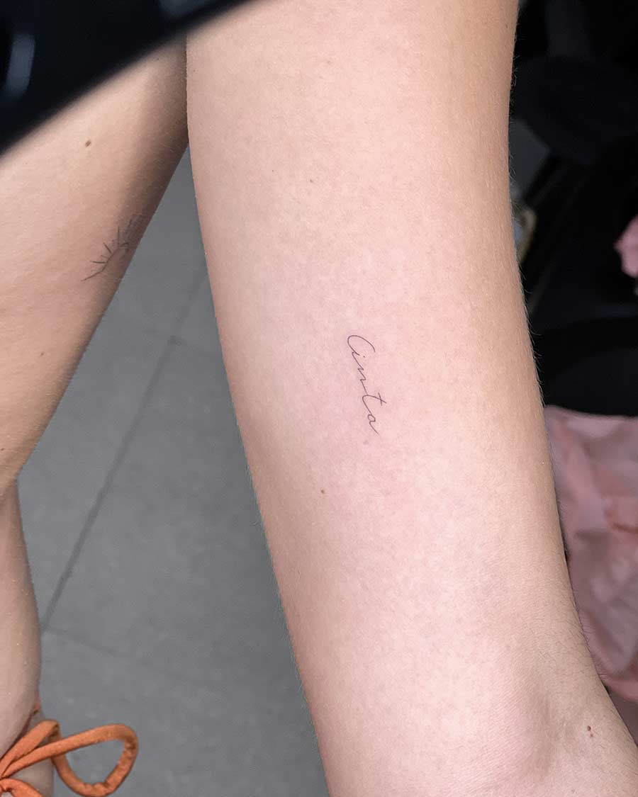 tattoo script lettering on the hand fineline cinta