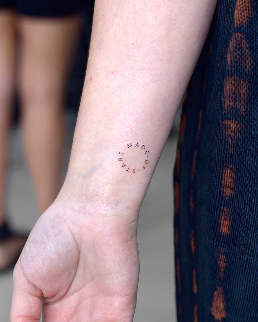 tattoo script lettering on the hand fineline circle made of stars