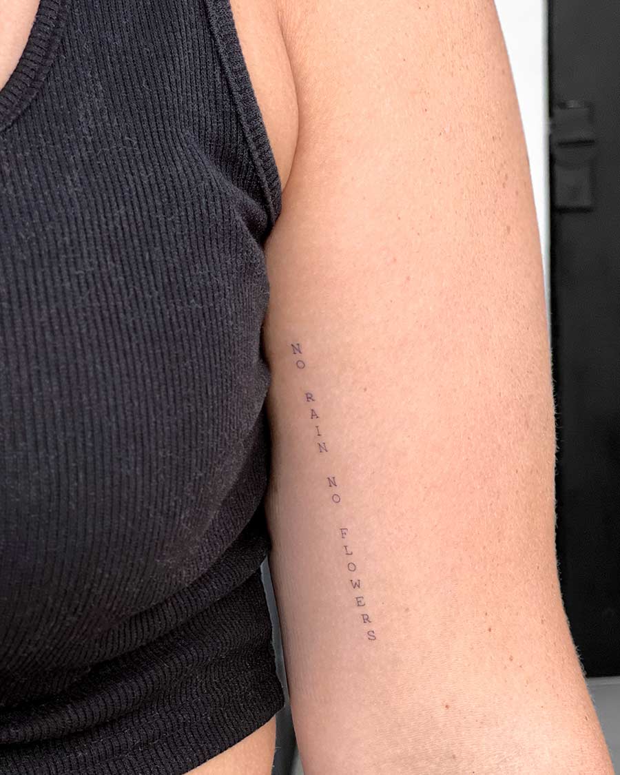 tattoo script lettering on the hand fineline typewriter fineline No rain no flowers