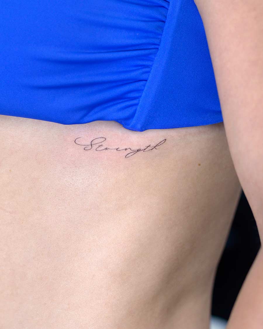 tattoo script lettering on the side fineline strenght