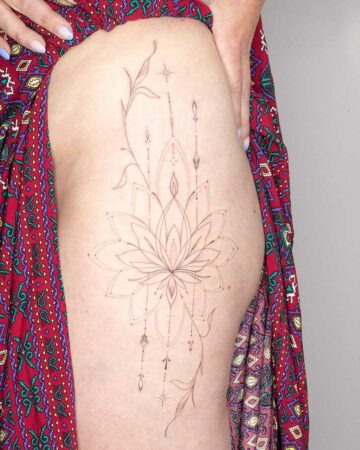 Detailed ornamental fine line tattoo design mandala floral elements dots lotus on leg thigh by our artists in fine line tattoo studio Canggu Bali