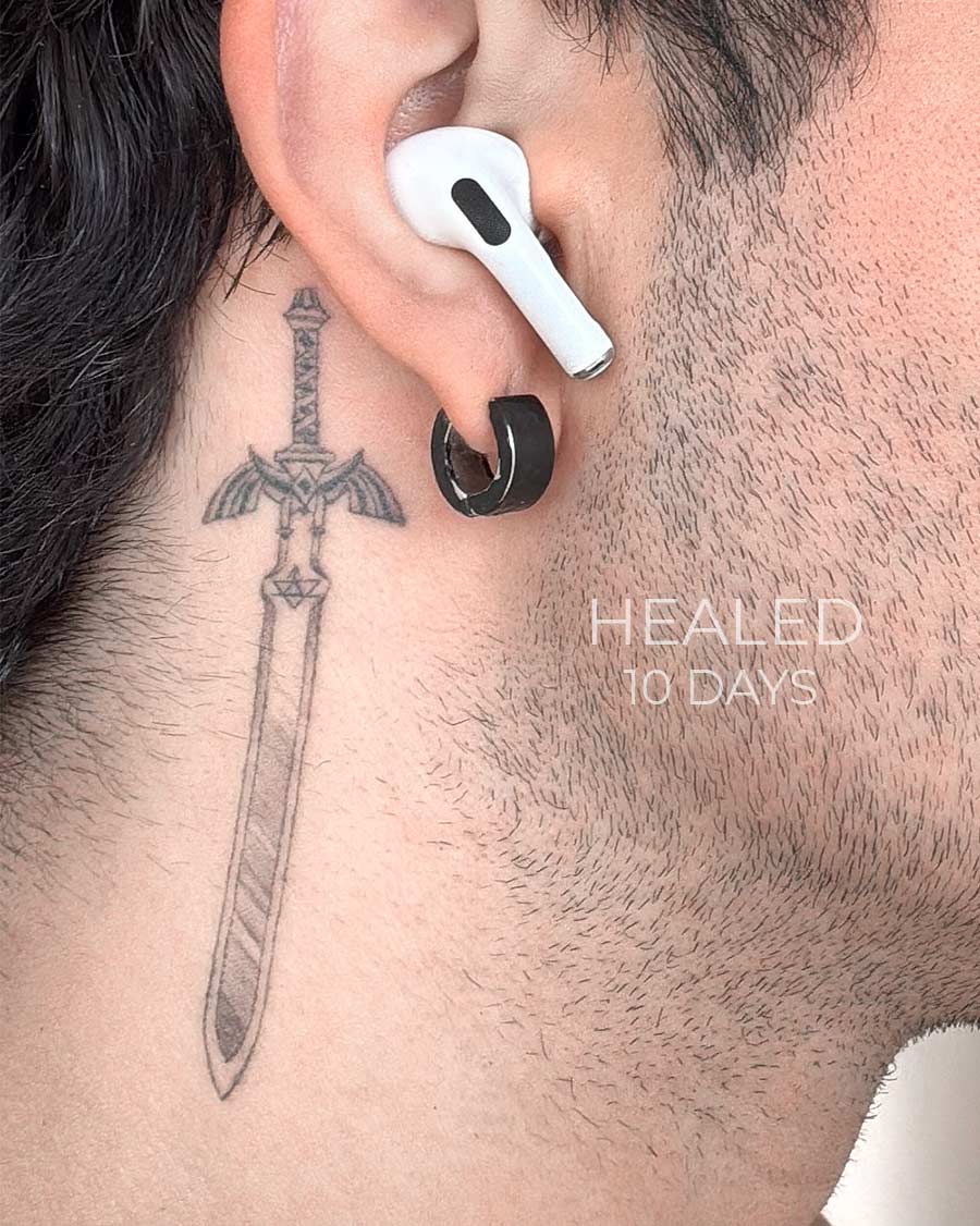 master sword from anime healed tattoo on the neck by our artists in fine line tattoo studio Canggu Bali