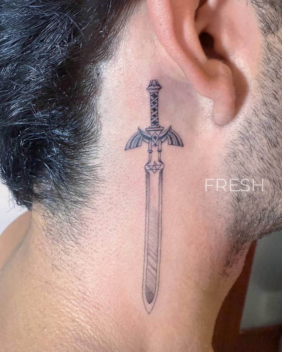 master sword from anime tattoo on the neck by our artists in fine line tattoo studio Canggu Bali