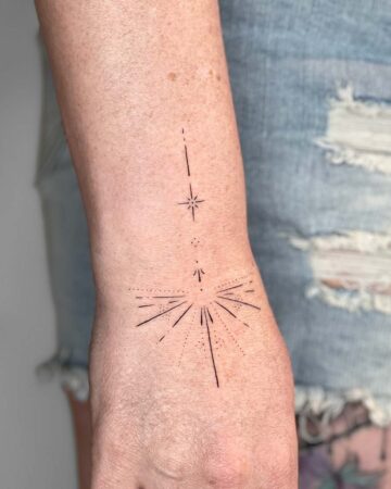 Minimalist starburst tattoo on arm minimalist geometry by our artists in fine line tattoo studio Canggu Bali