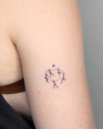 tiny fine line tattoo dancing abstract figures on the upper arm by our artists in fine line tattoo studio Canggu Bali