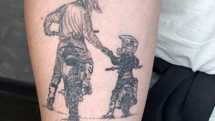 enduro-bike-father-with-son-healed-blacgrey-realistic-tattoo-on the arm canggu-bali-tattoo-studio