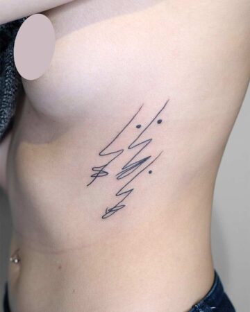 A woman's side profile shows a minimalist tattoo on her ribcage. The tattoo features a series of delicate, abstract lines with small dots, a modern example of minimalist tattoos.