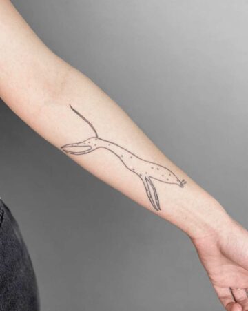 Minimalist line art tattoo of a stylized cheetah tattoo, on a forearm. Bali tattoo design.