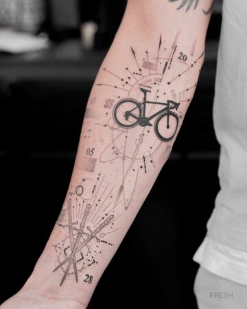 A healed tattoo gallery image showcases a forearm tattoo featuring a detailed black bicycle design, crossed swords, and geometric elements. Numbers "03," "05," "20," and "28" are incorporated into the design.