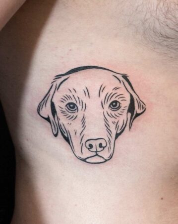 A simple, fine-line dog tattoo on a person's ribs. A beautiful example of a dog tattoo. Created by the best tattoo artists in Canggu, Bali. Find the best Bali tattoo artist here.
