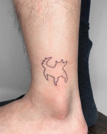 Minimalist dog tattoo on an ankle, a simple black outline design. A unique dog tattoo choice. Created by the best tattoo artists in Canggu Bali, Bali tattoo studio.