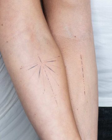 Close-up of matching minimalist tattoos on two arms feauturing Morse code. One arm features a radiating design, while the other has a simple dotted line. A unique couples tattoo idea. Canggu Bali tattoo artist.
