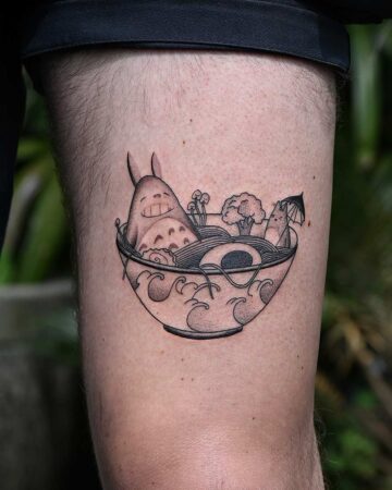 A whimsical Japanese tattoo of Totoro in a noodle bowl, complete with toppings. This unique japan tattoo design is a fun take on oriental art. Created in the multi style tattoo studio in Canggu Bali.