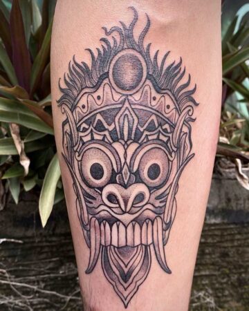 Close-up of a Barong tattoo on a person's arm, showcasing intricate line work and shading. This Barong tattoo design captures the essence of Balinese artistry. Created by the best expert tattoo artists in Canggu Bali.